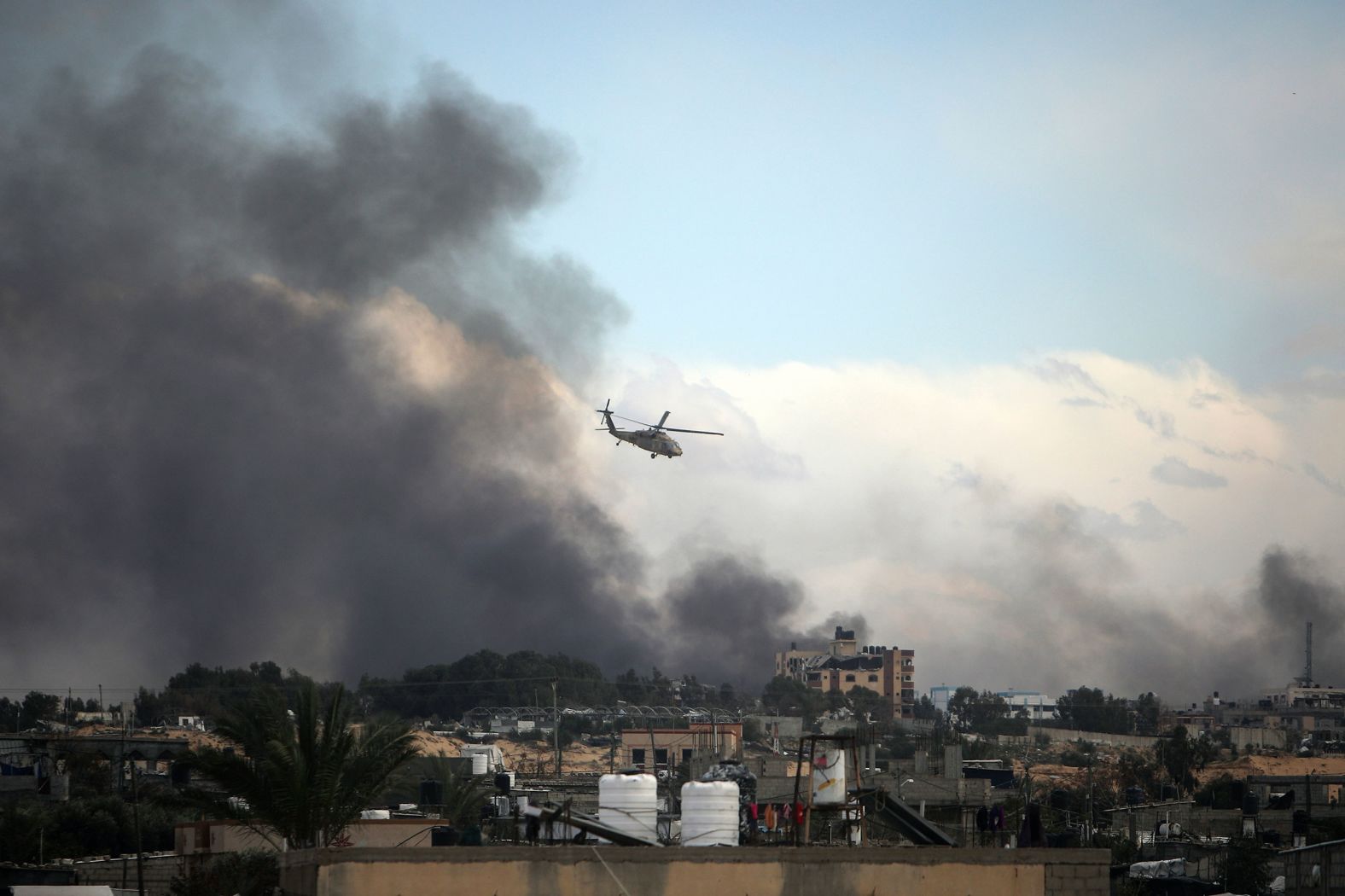 An Israeli helicopter flies over Khan Younis, Gaza, on Thursday, February 15. <a href="index.php?page=&url=https%3A%2F%2Fwww.cnn.com%2F2024%2F02%2F10%2Fmiddleeast%2Fkhan-younis-devastation%2Findex.html" target="_blank">The besieged city in southern Gaza</a> is the hometown of Hamas' leader in Gaza, Yahya Sinwar, and according to the Israel Defense Forces it is a major Hamas stronghold.