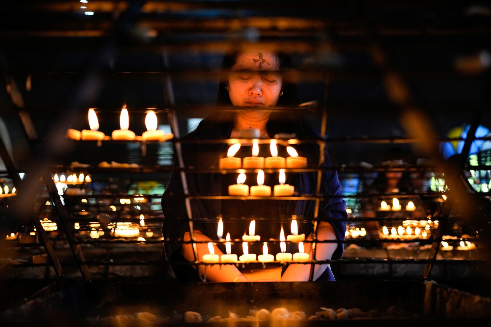 A woman prays at the Redemptorist Church in Manila, Philippines, during Ash Wednesday rites on February 14.