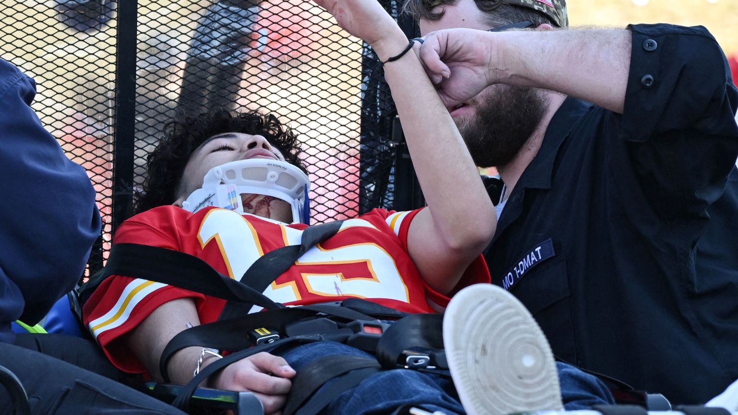 An injured person is aided near the Kansas City Chiefs' Super Bowl LVIII victory parade on February 14, 2024, in Kansas City, Missouri. Shots were reportedly fired during the parade, according to police. (Photo by Andrew CABALLERO-REYNOLDS / AFP) (Photo by ANDREW CABALLERO-REYNOLDS/AFP via Getty Images)