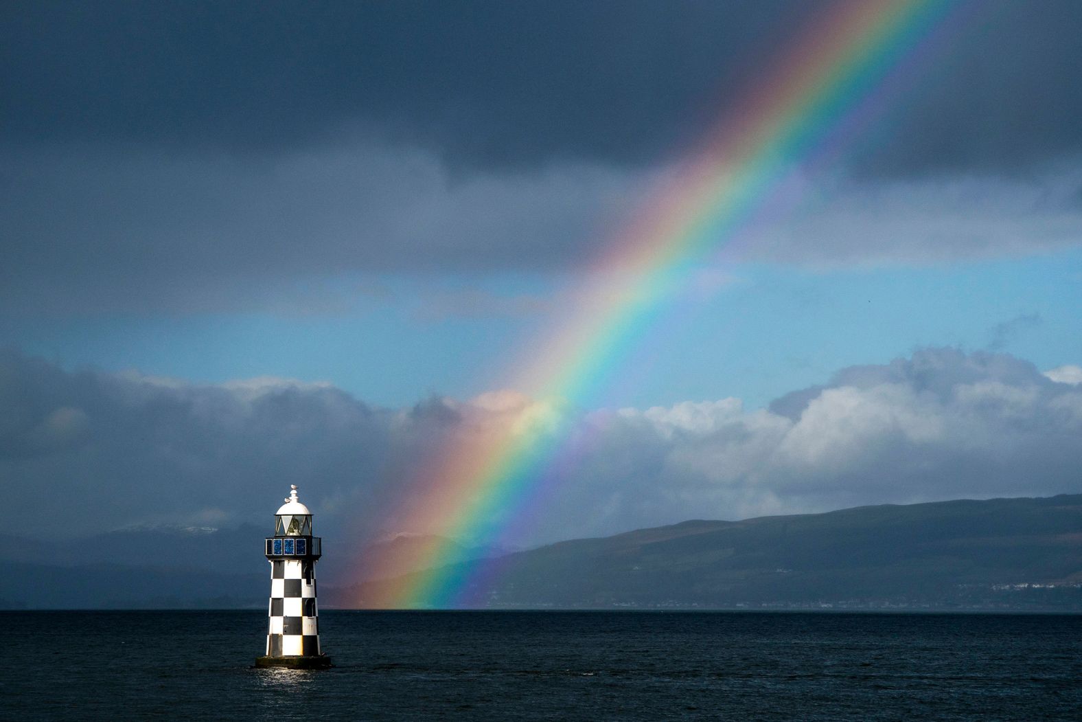A rainbow is seen behind the Perch Lighthouse in Port Glasgow, Scotland, on Tuesday, February 13.