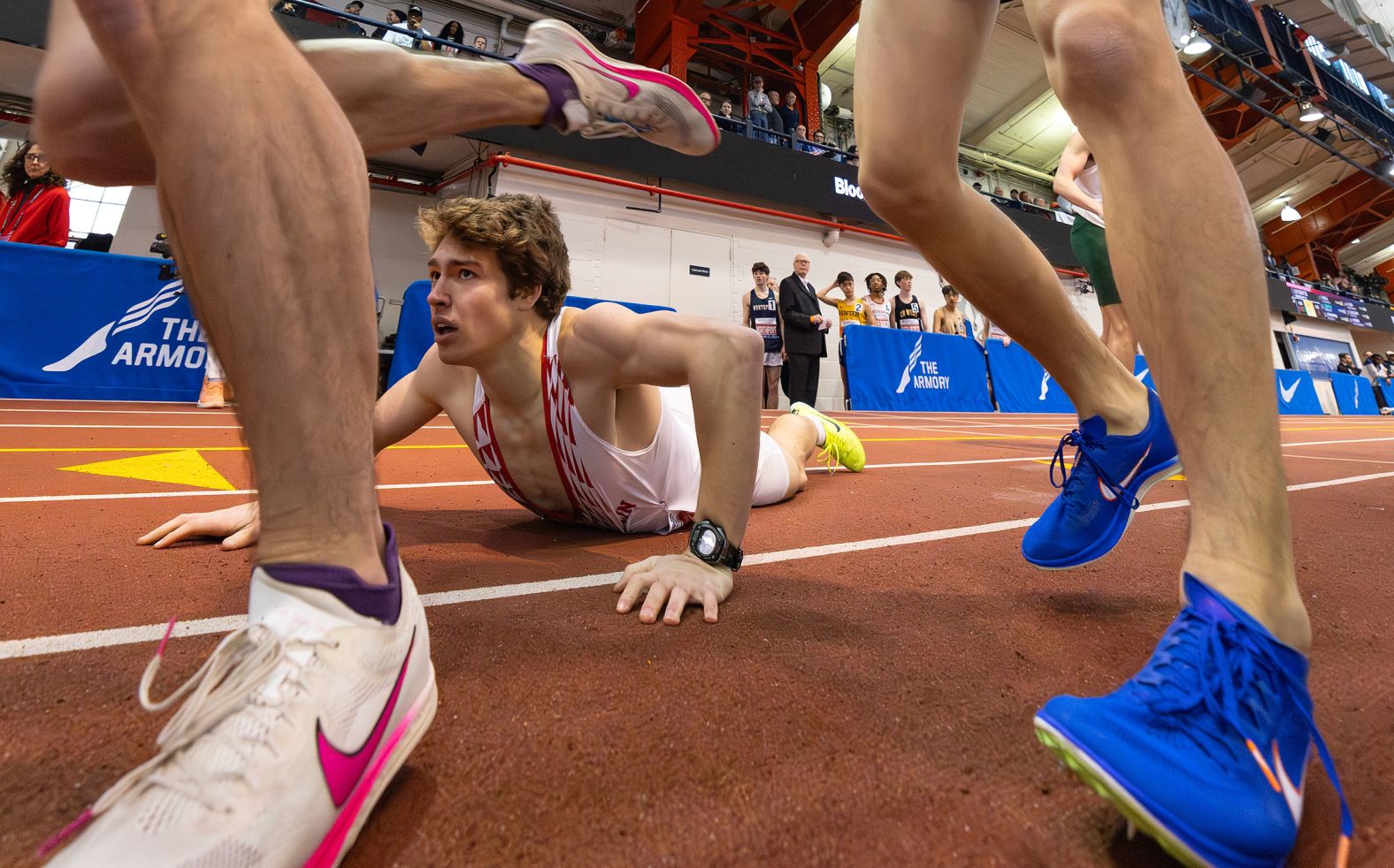 A runner takes a tumble during a relay race at the Millrose Games in New York on Sunday, February 11.