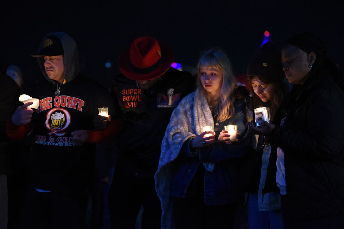 People attend a candlelight vigil at Skywalk Memorial Plaza in Kansas City, Missouri, on February 15, 2024. At least one person is dead and nearly two dozen people are injured after a shooting took place at the end of a rally for the Super Bowl-winning Kansas City Chiefs on Wednesday. (Emmalee Reed/CNN)
