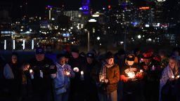 People attend a candlelight vigil at Skywalk Memorial Plaza in Kansas City, Missouri, on February 15, 2024. At least one person is dead and nearly two dozen people are injured after a shooting took place at the end of a rally for the Super Bowl-winning Kansas City Chiefs on Wednesday. (Emmalee Reed/CNN)