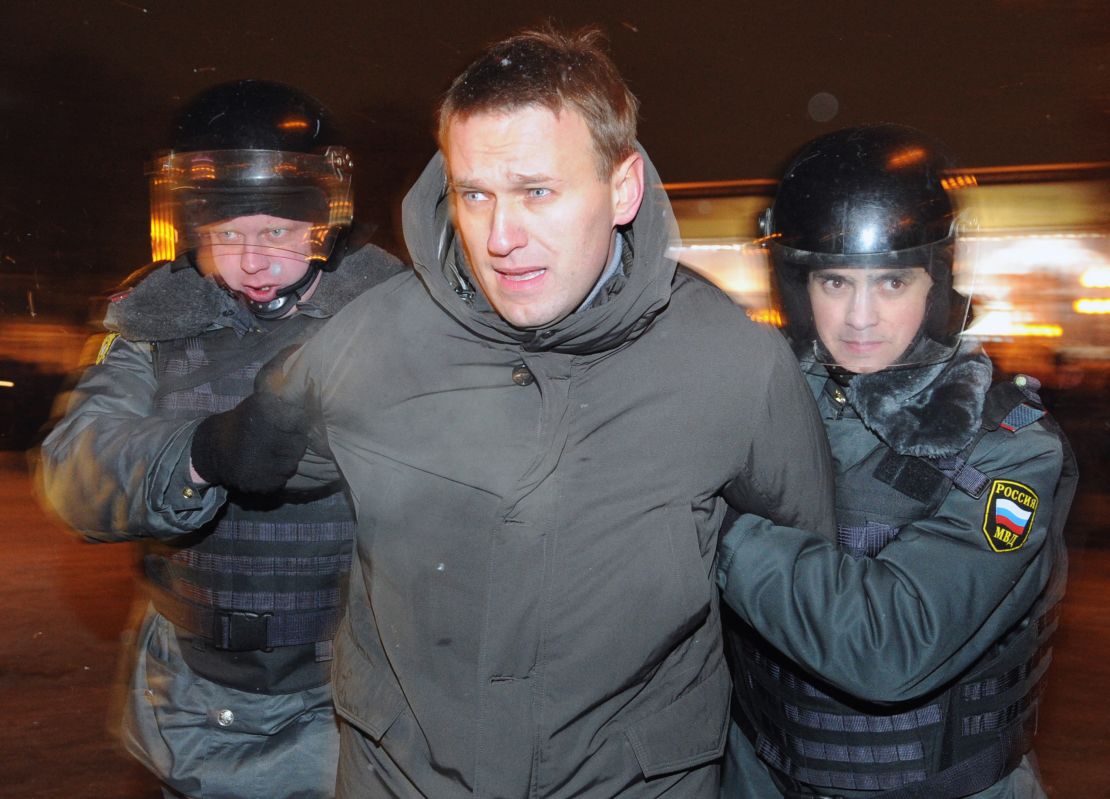 TOPSHOT - Police officers detain one of the protest movement leaders, Alexei Navalny, at Moscow's Pushkinskaya Square, on March 5, 2012, as the protesters refuse to leave the venue at the end of their larger rally earlier. Russian police broke up today a protest in central Moscow against Vladimir Putin's victory in presidential elections, roughly arresting dozens of people, an AFP correspondent said.   AFP PHOTO / ALEXANDER NEMENOV (Photo by ALEXANDER NEMENOV / AFP) (Photo by ALEXANDER NEMENOV/AFP via Getty Images)