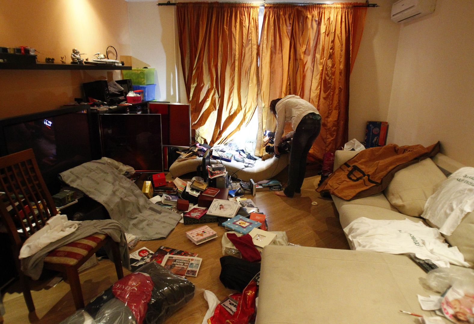 A journalist films Navalny's apartment in Moscow after it was searched by police in June 2012.