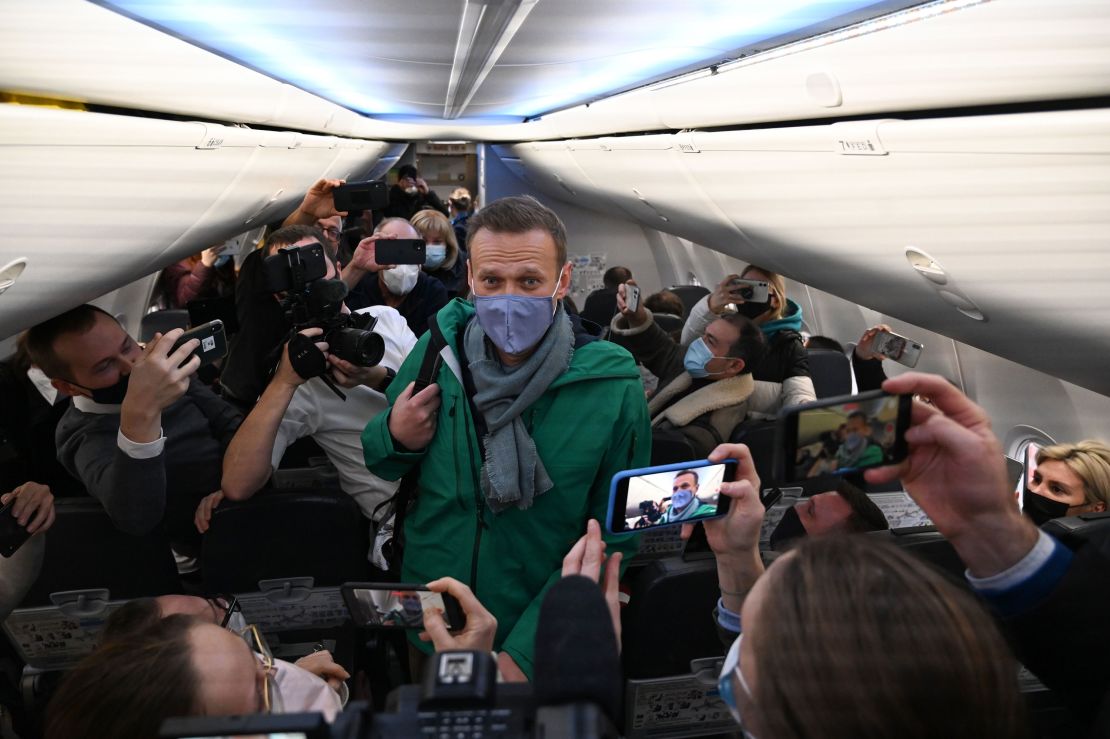 TOPSHOT - Russian opposition leader Alexei Navalny walks to take his seat in a Pobeda airlines plane heading to Moscow before take-off from Berlin Brandenburg Airport (BER) in Schoenefeld, southeast of Berlin, on January 17, 2021. - Chief Kremlin critic Alexei Navalny returns to Russia from Germany on January 17, facing imminent arrest after authorities warned they would detain him. The 44-year-old opposition leader is flying back to Moscow after spending several months in Germany recovering from a poisoning attack that he said was carried out on the orders of President Vladimir Putin. (Photo by Kirill KUDRYAVTSEV / AFP) (Photo by KIRILL KUDRYAVTSEV/AFP via Getty Images)