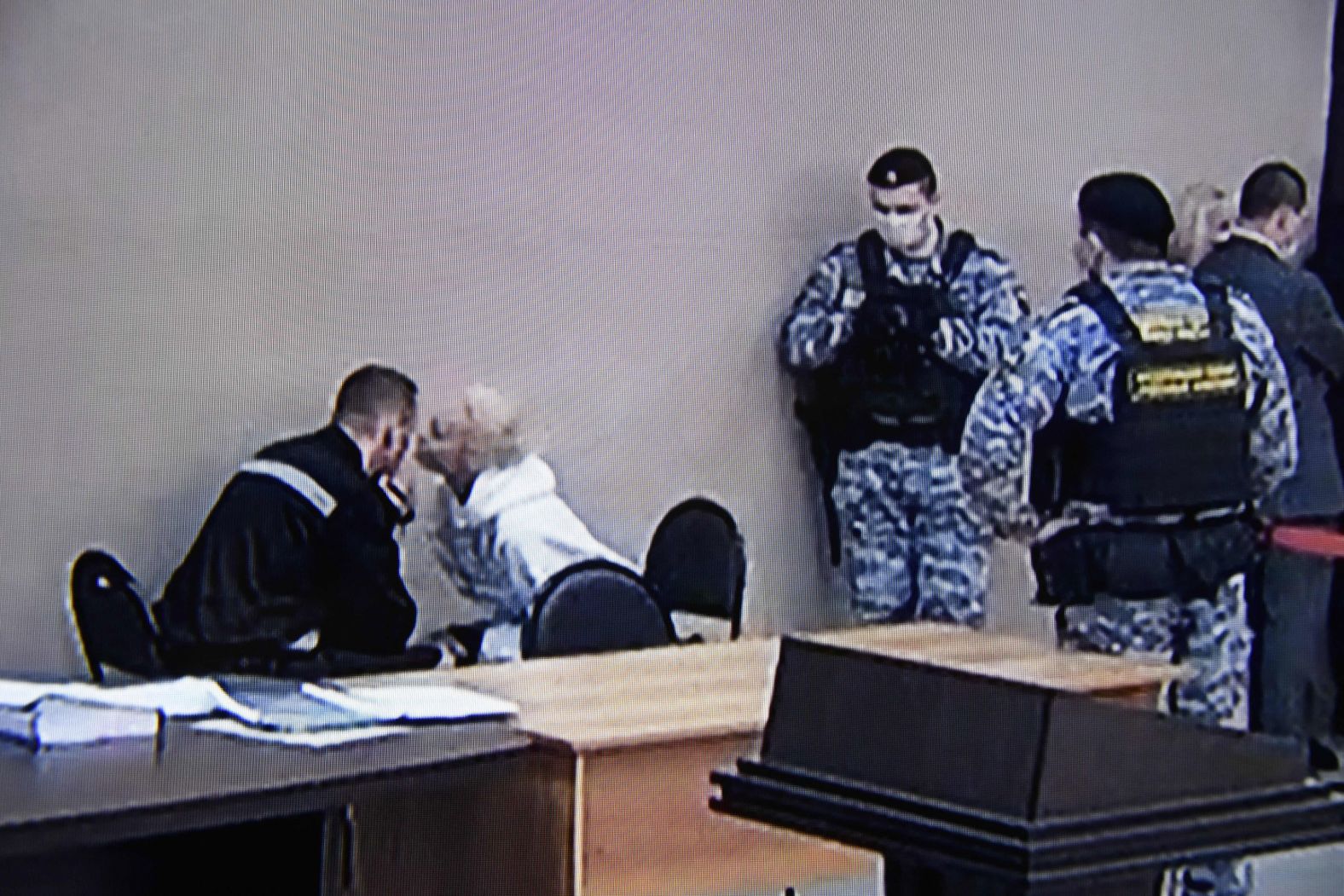 In this image, taken from a TV screen during a live broadcast of a court hearing, Navalny speaks with his wife, Yulia, on the first day of his new trial in Pokrov, Russia, in February 2022. Navalny was sentenced to nine years in a maximum-security jail, according to the Russian state-owned news agency Tass, after being convicted on fraud charges over allegations that he stole from his Anti-Corruption Foundation.