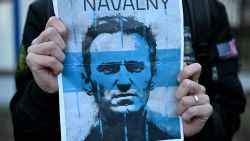 A demonstrator carries a placard with a picture of late Russian opposition leader Alexei Navalny as people gather to attend a rally in front of the Russian Embassy in Warsaw on February 16, 2024, following the announcement that the Kremlin's most prominent critic Alexei Navalny had died in an Arctic prison. Russian opposition leader Navalny died on February 16 at the Arctic prison colony in Russia's Yamalo-Nenets region in northern Siberia where he was serving a 19-year-term. Russian authorities announced Navalny's death a month before an election poised to extend Russian President Putin's hold on power. (Photo by Sergei GAPON / AFP) (Photo by SERGEI GAPON/AFP via Getty Images)
