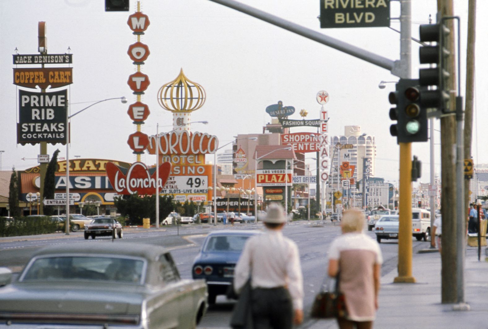 People walk near the intersection of the Las Vegas Strip and Riviera Boulevard in 1975.