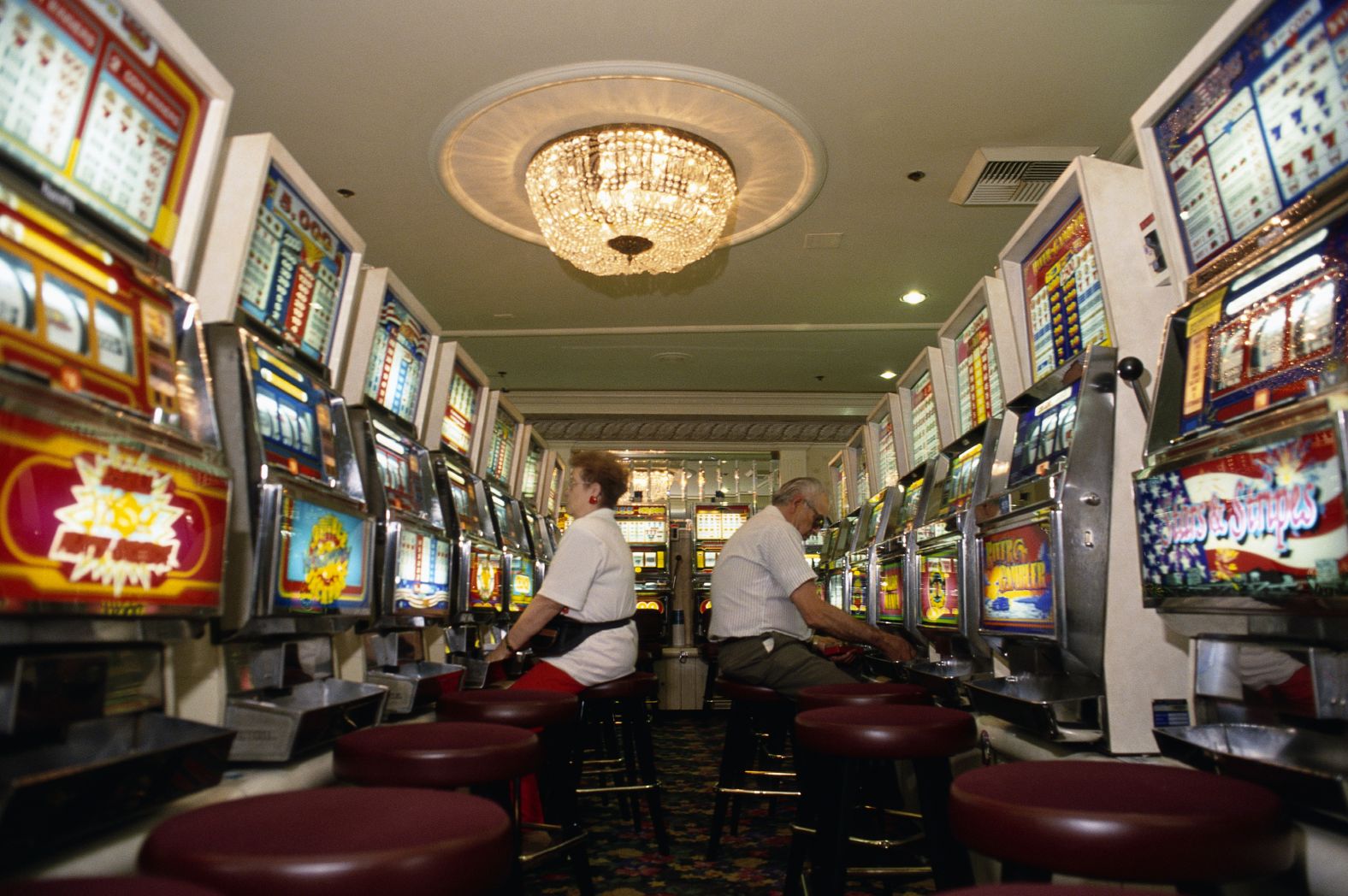 People play slot machines at the Harrah's Casino in Las Vegas in 1994.