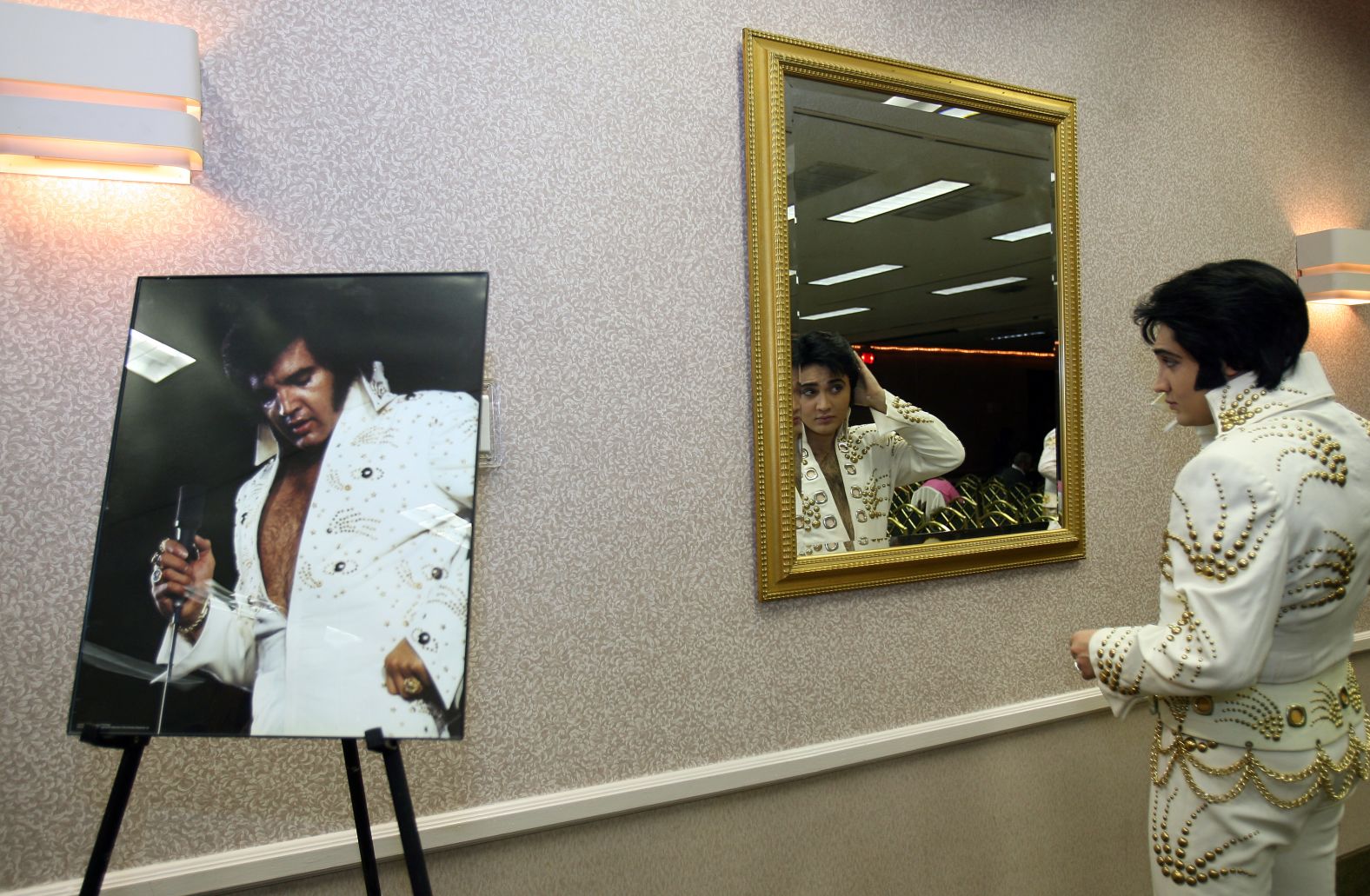 Justin Shandor checks his wig before participating in an Elvis lookalike contest in 2006.