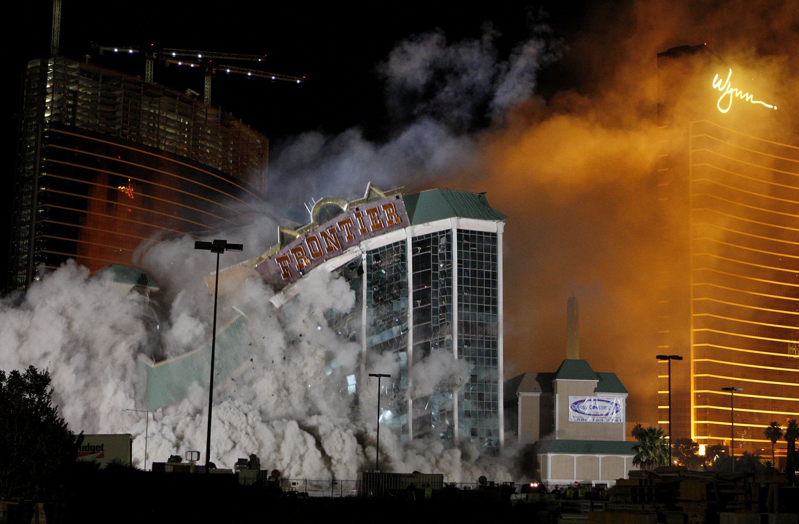 The New Frontier, one of the oldest hotels and casinos on the Strip, is imploded in 2007. Behind it are two of the newer Wynn resorts.