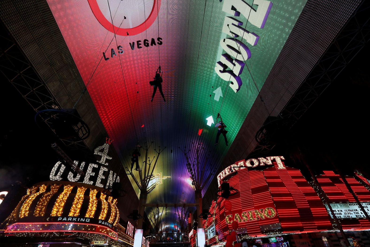 People ride a zip line above Fremont Street in 2020.