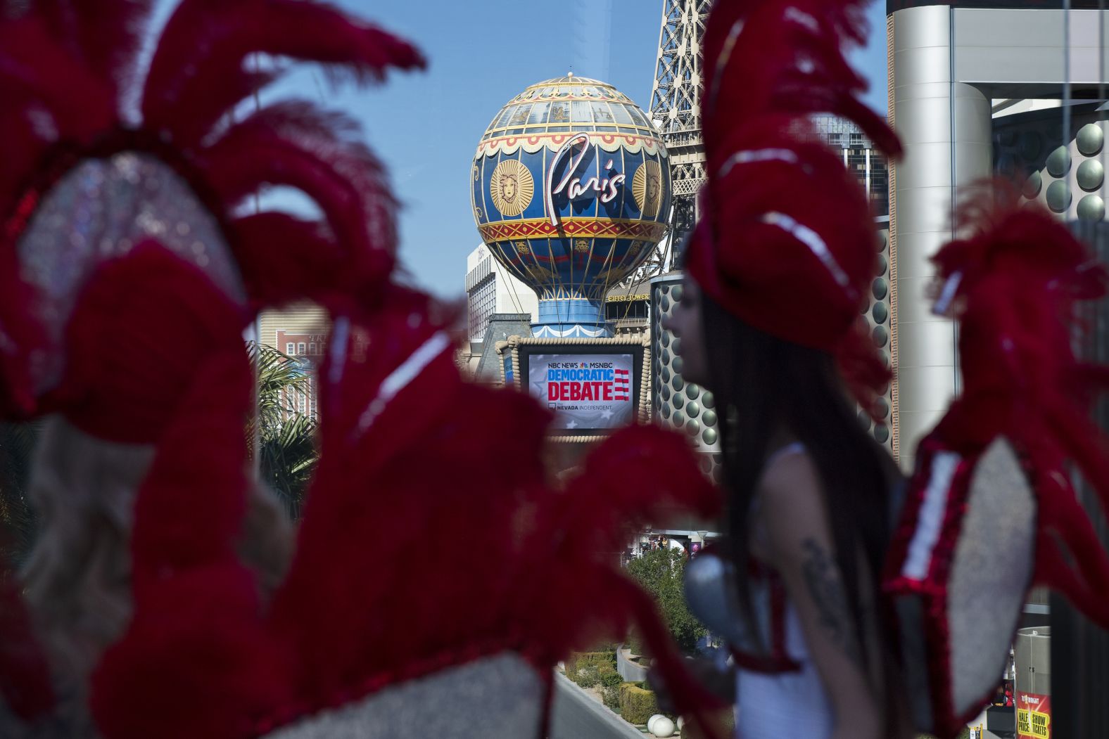 Showgirls walk near the Paris casino, which was hosting a Democratic presidential debate in 2020.