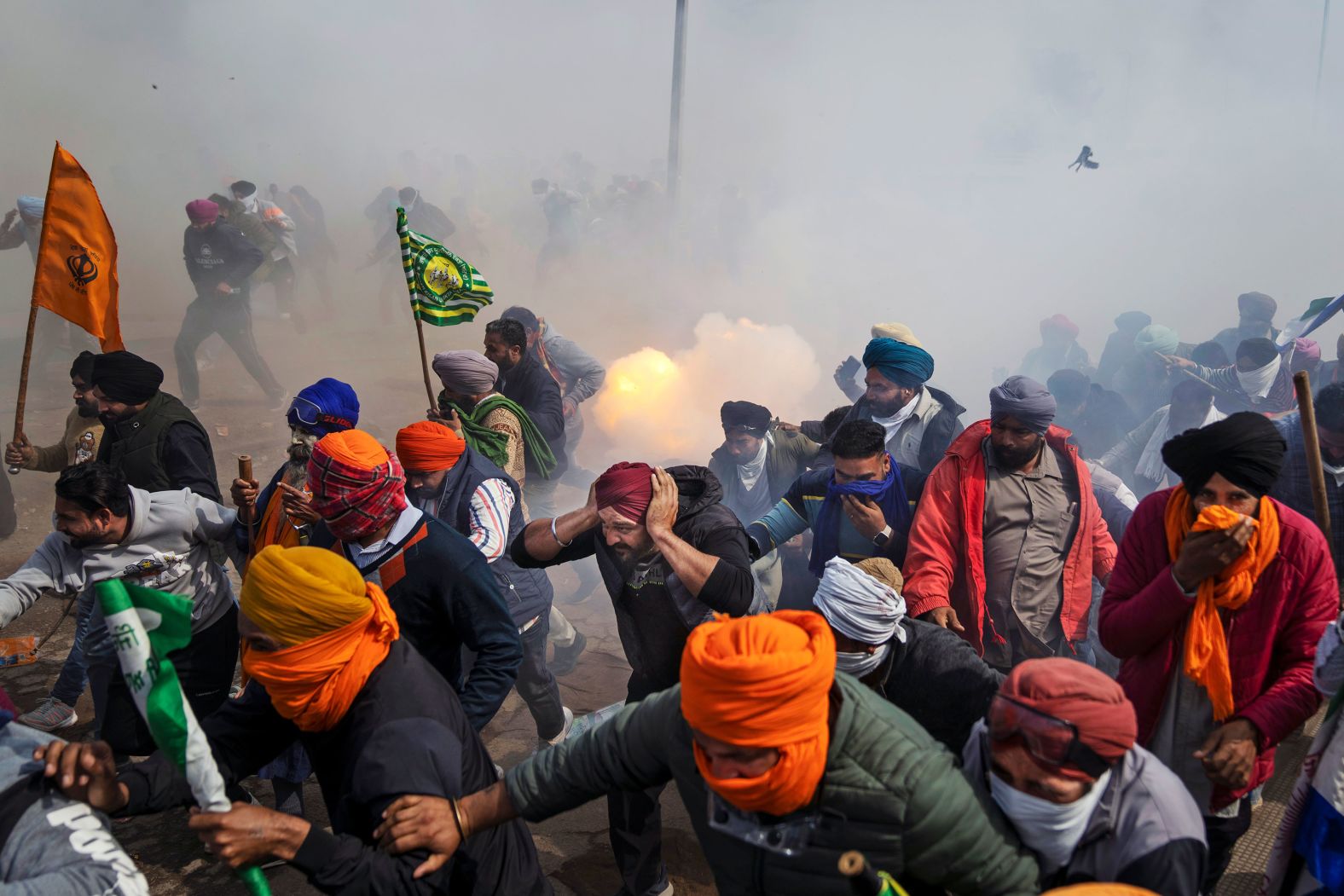 Protesting farmers run away from exploding tear gas shells used by the police near the Shambhu border that divides the northern Punjab and Haryana states in India on Wednesday, February 21. The farmers, <a href="index.php?page=&url=https%3A%2F%2Fwww.cnn.com%2Fvideos%2Fworld%2F2024%2F02%2F13%2Fexp-india-farmers-protests-sud-live-021308aseg2-cnni-world.cnn" target="_blank">demanding higher prices for their crops</a>, began their march to the Indian capital last week. But their efforts to reach the city have been blocked by authorities.