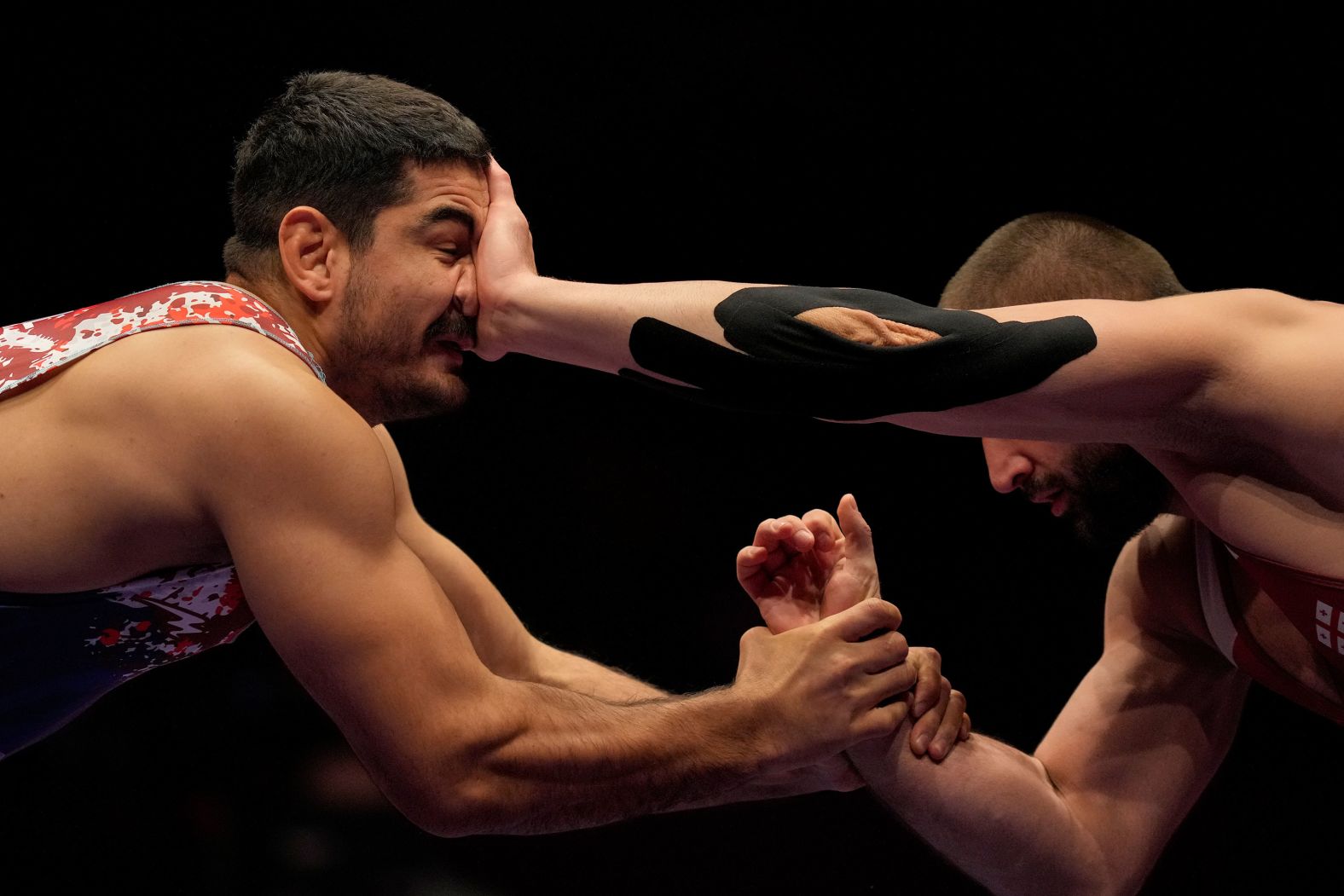 Turkish freestyle wrestler Taha Akgül, left, competes with Georgia's Geno Petriashvili at the European Wrestling Championships on Sunday, February 18. Akgül defeated Petriashvili to win the gold medal in their weight class.