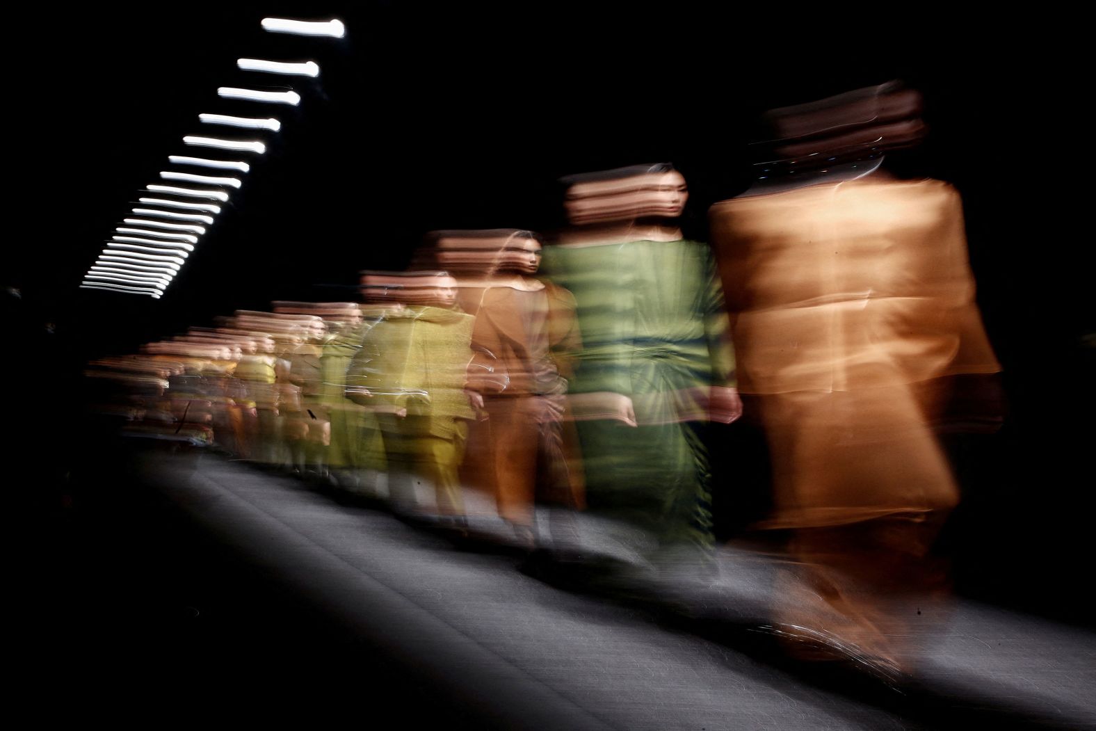 In this long-exposure photo, models take part in an Alberta Ferretti fashion show in Milan, Italy, on Wednesday, February 21.
