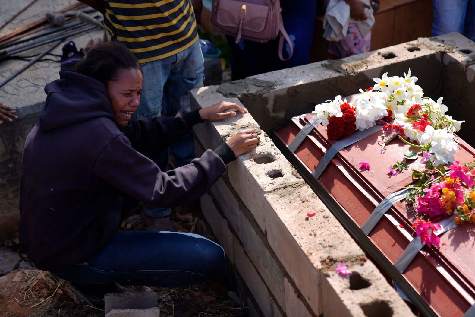 A sister of miner Santiago Mora cries as he is buried at a cemetery in La Paragua, Venezuela, on Thursday, February 22. <a href="index.php?page=&url=https%3A%2F%2Fwww.cnn.com%2F2024%2F02%2F21%2Famericas%2Fvenezuela-gold-mine-collapse-intl-latam%2Findex.html" target="_blank">A gold mine in the town collapsed</a>, according to the town's mayor.