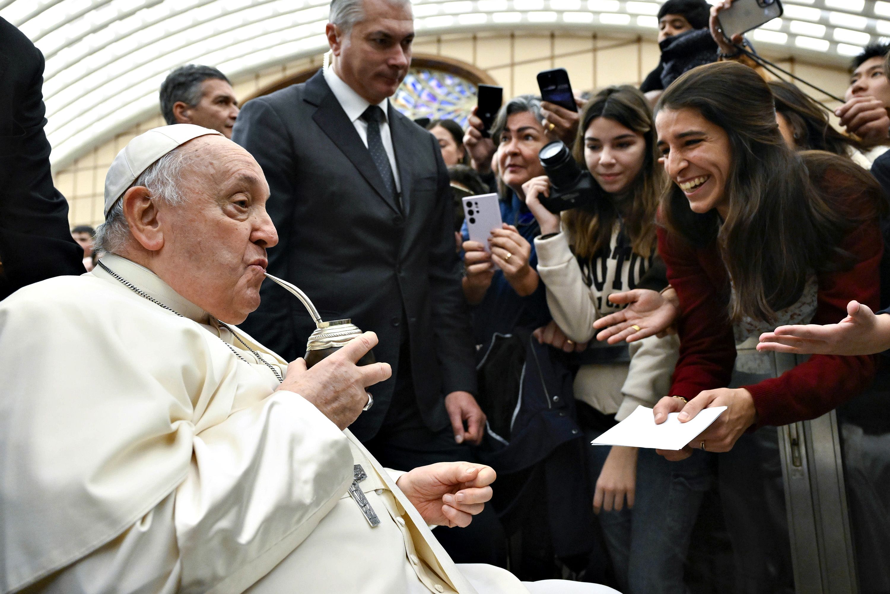 The Pope drinks mate offered by Argentinian pilgrims who were visiting the Vatican in January 2024.