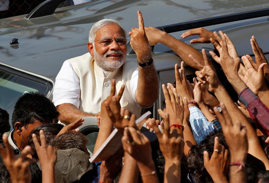 Hindu nationalist Narendra Modi, the prime ministerial candidate for India's main opposition Bharatiya Janata Party (BJP), shows his ink-marked finger to his supporters after casting his vote at a polling station during the seventh phase of India's general election in the western Indian city of Ahmedabad April 30, 2014. Around 815 million people have registered to vote in the world's biggest election - a number exceeding the population of Europe and a world record - and results of the mammoth exercise, which concludes on May 12, are due on May 16.