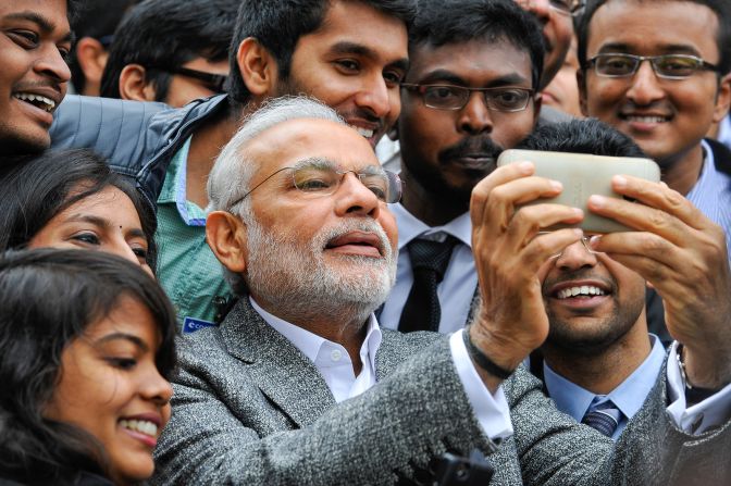 Modi poses with Indian students during a visit to the French National Space Agency in Toulouse, France, on April 11, 2015. 