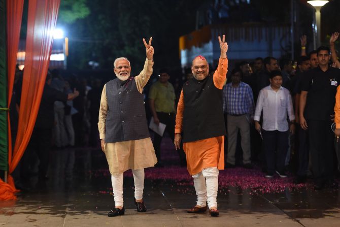 Modi and with India's Home Secretary Amit Shah celebrate the BJP's roaring victory in the country's general election in New Delhi on May 23, 2019. 