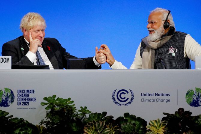 With former British Prime Minister Boris Johnson during the COP26 UN Climate Summit in Glasgow on November 2, 2021.