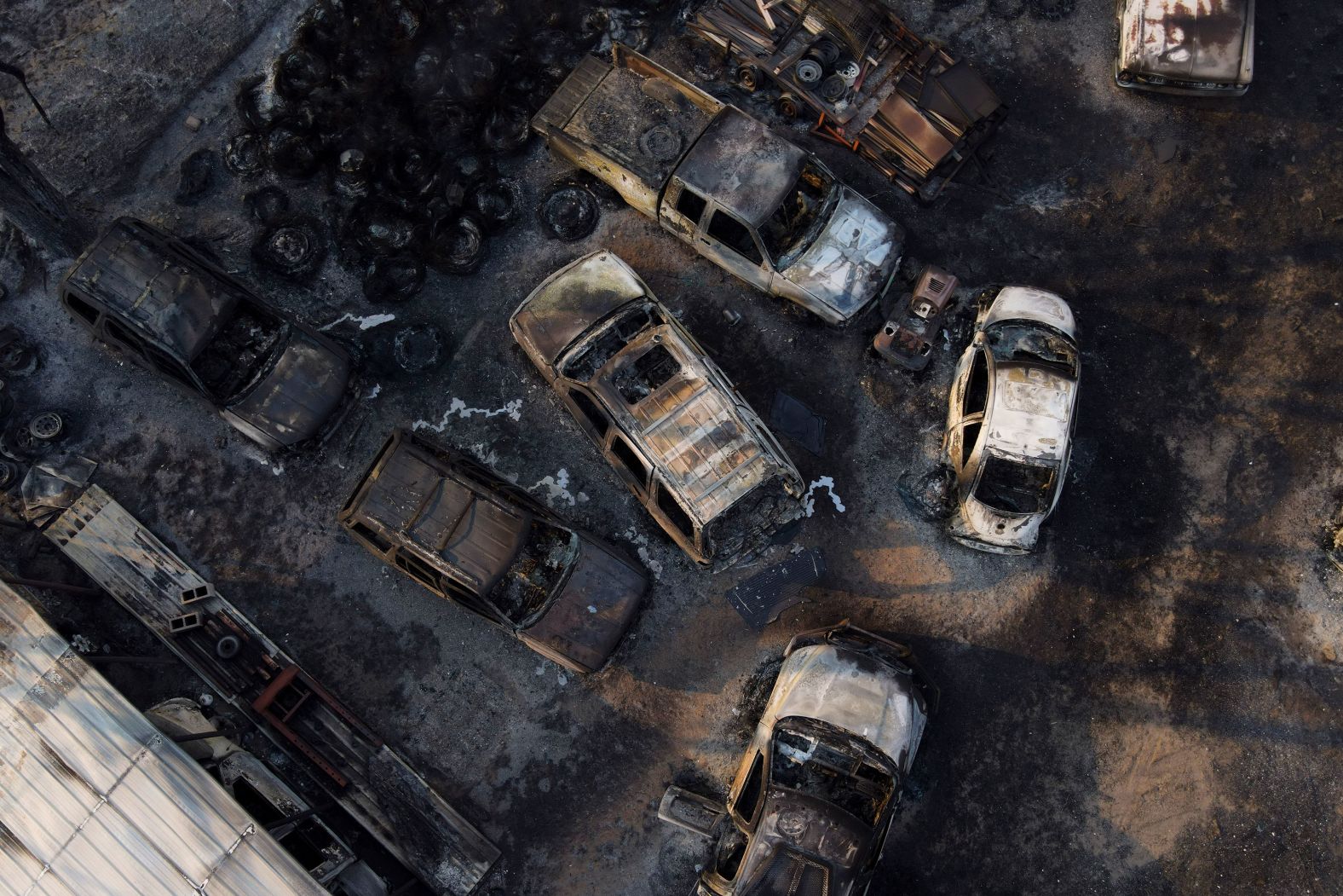 Charred vehicles sit at an auto body shop in Canadian, Texas, on Wednesday, February 28. The property was burned by the <a href="index.php?page=&url=https%3A%2F%2Fwww.cnn.com%2F2024%2F02%2F29%2Fus%2Ftexas-panhandle-smokehouse-creek-fire-thursday%2Findex.html" target="_blank">Smokehouse Creek Fire</a>, which has torched more than 1 million acres and is the largest wildfire on record in the state.