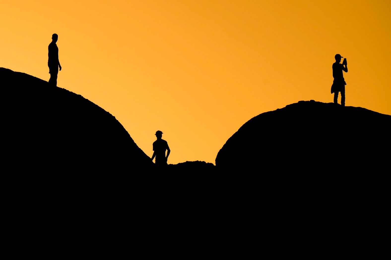 People are silhouetted against the sunset at Phoenix's Papago Park on Tuesday, February 27.