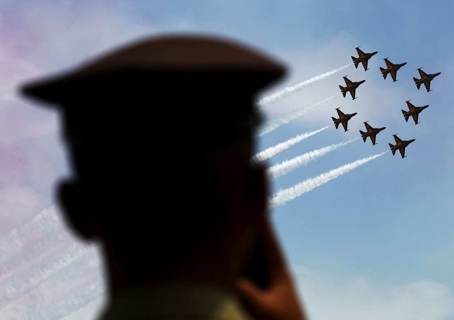 An Indonesian Air Force cadet watches the South Korea Air Force's Black Eagles aerobatics team perform during the Singapore Airshow on Thursday, February 22. <a href="index.php?page=&url=http%3A%2F%2Fwww.cnn.com%2F2024%2F02%2F22%2Fworld%2Fgallery%2Fphotos-this-week-february-15-february-22%2Findex.html" target="_blank">See last week in 30 photos</a>.