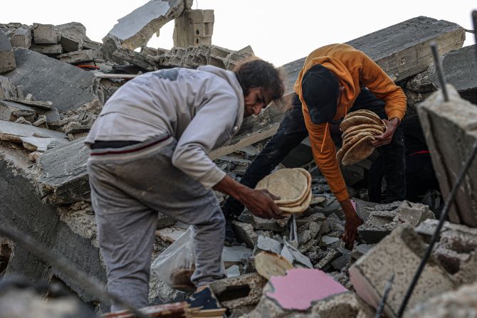 Men salvage bread that was found amid the rubble of a family's home in Rafah on March 3.