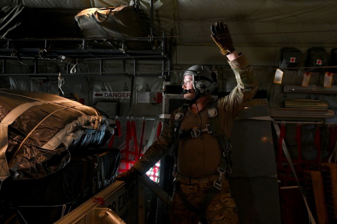 A member of the US Air Force prepares to release humanitarian aid pallets of packaged food over Gaza on March 5.