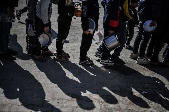 Palestinians line up for food distribution in Rafah on February 1.