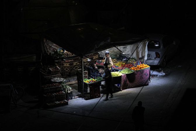 Vendors selling vegetables wait for customers at their roadside stall in Rafah on February 26.