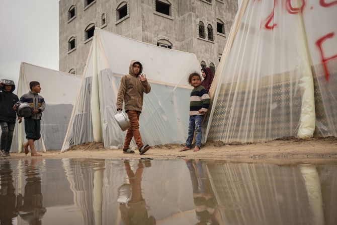 A child waves at a displacement camp in Gaza on January 27.