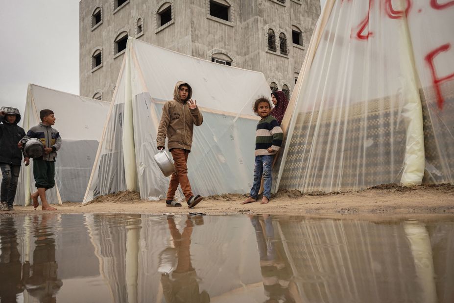 A child waves at a displacement camp in Gaza on January 27.