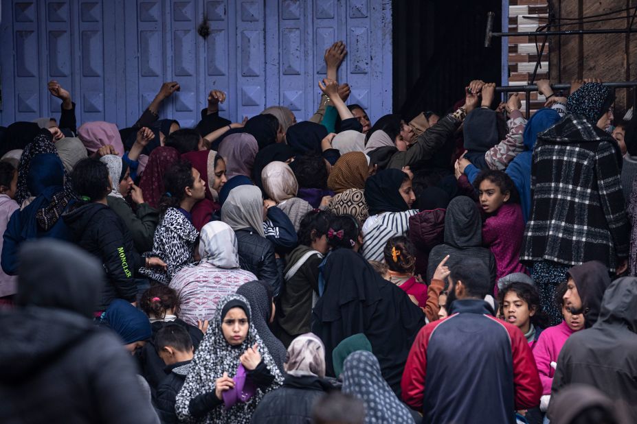 People in a crowd struggle to buy bread from a bakery in Rafah on February 18.