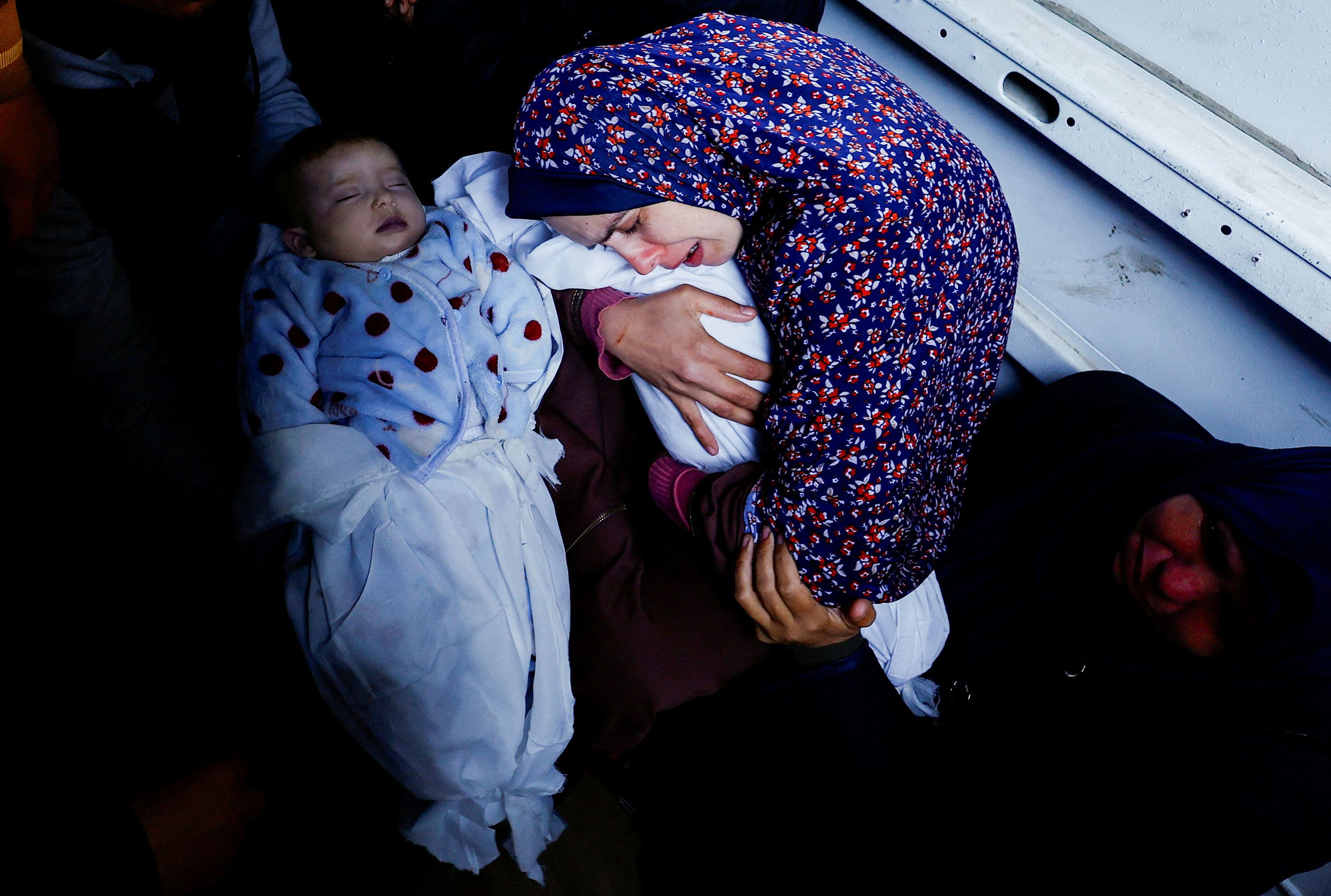 Rania Abu Anza holds one of her 5-month-old twins who were killed when an Israeli strike hit their house in Rafah, Gaza, on Sunday, March 3.