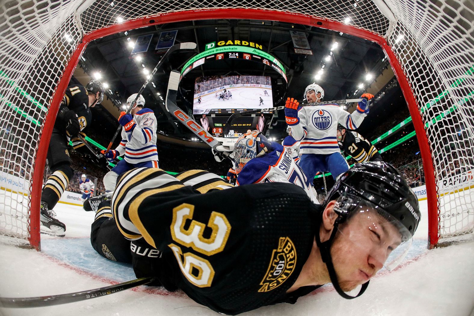 Boston Bruins center Morgan Geekie is dumped into the Edmonton Oilers' net during an NHL game in Boston on Tuesday, March 5.