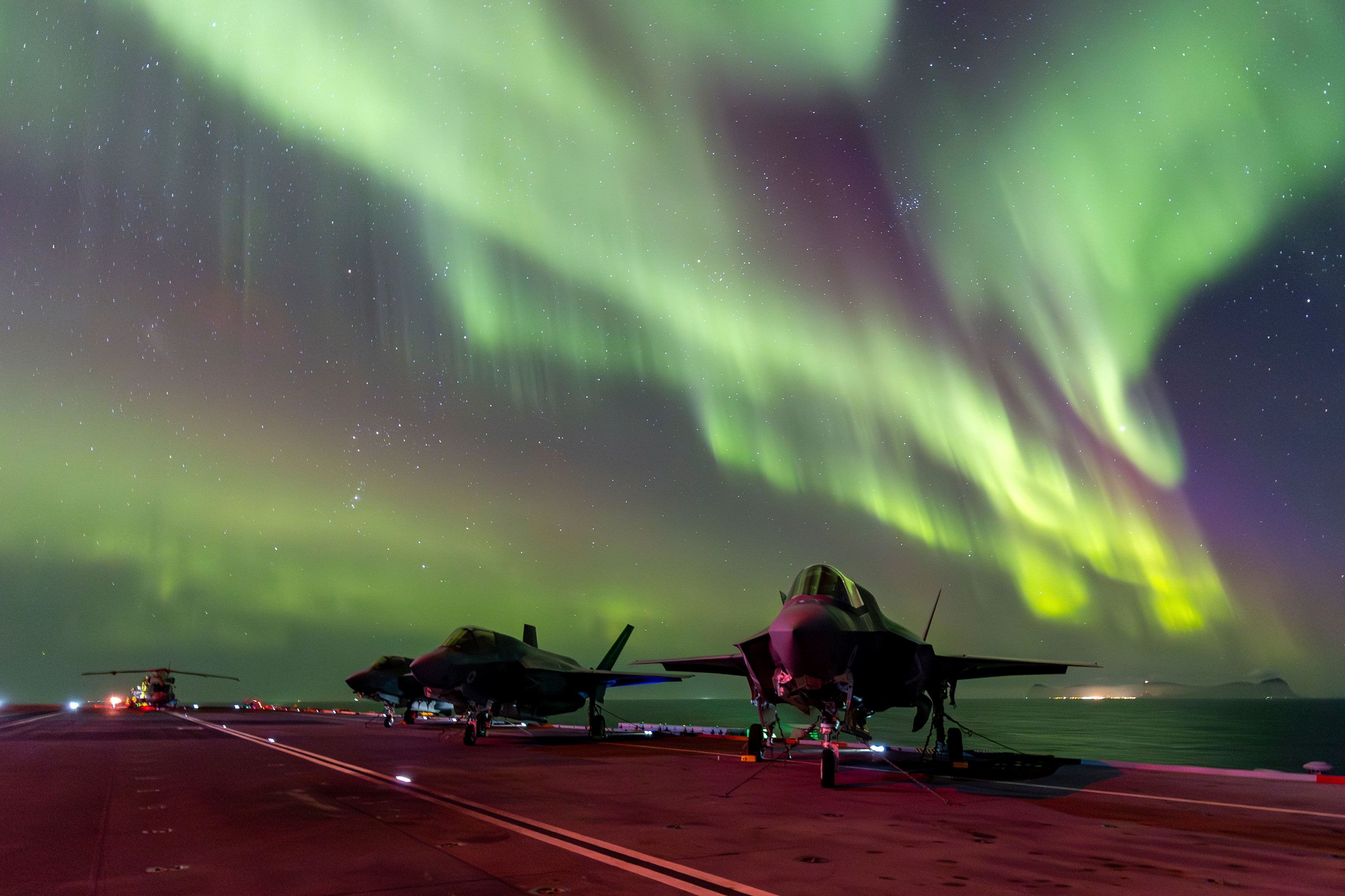 The northern lights are seen above British fighter jets parked on the HMS Prince of Wales, an aircraft carrier near the coast of Norway, on Sunday, March 3.