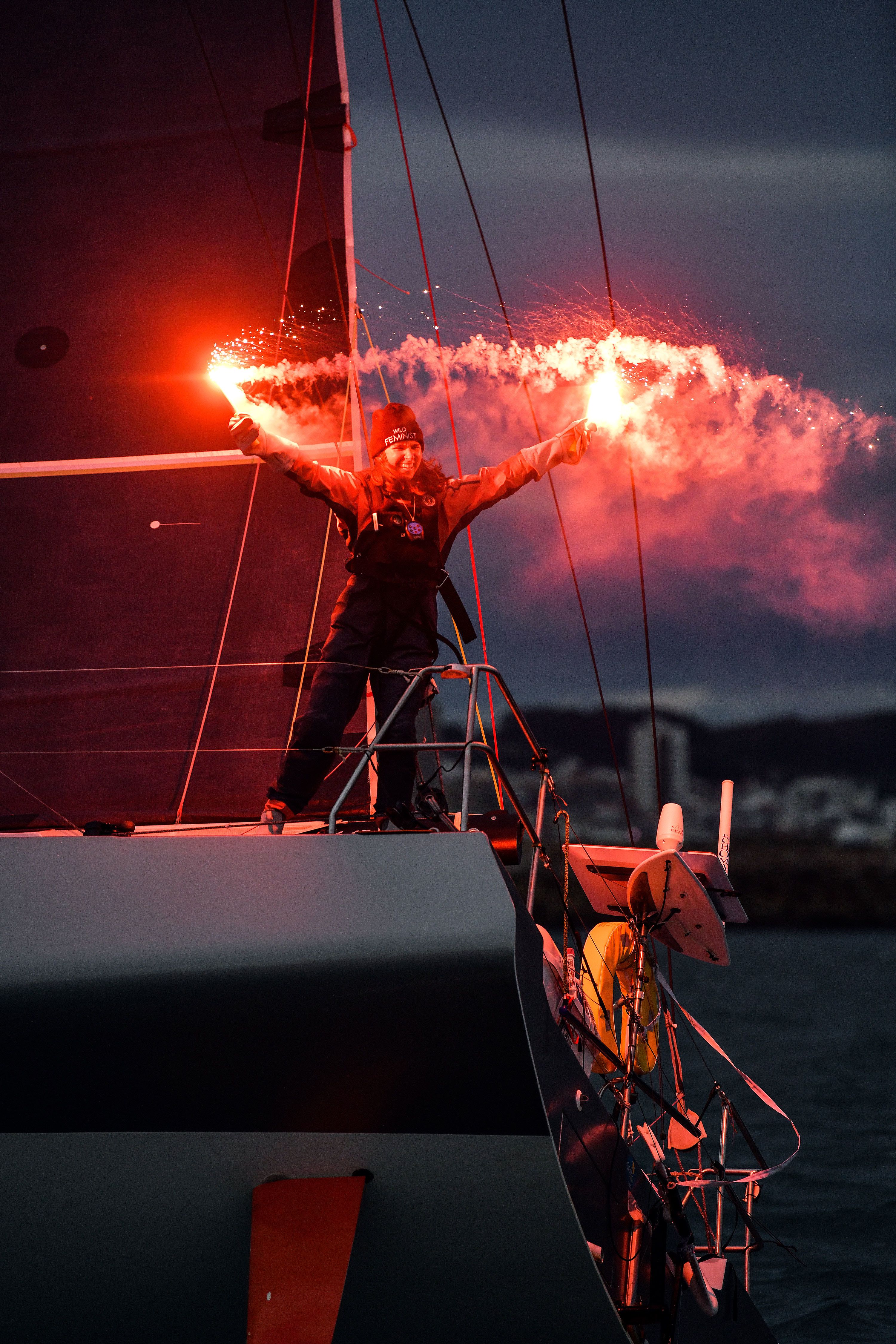 Cole Brauer celebrates Thursday, March 7, after she became the first American woman to sail solo around the world.