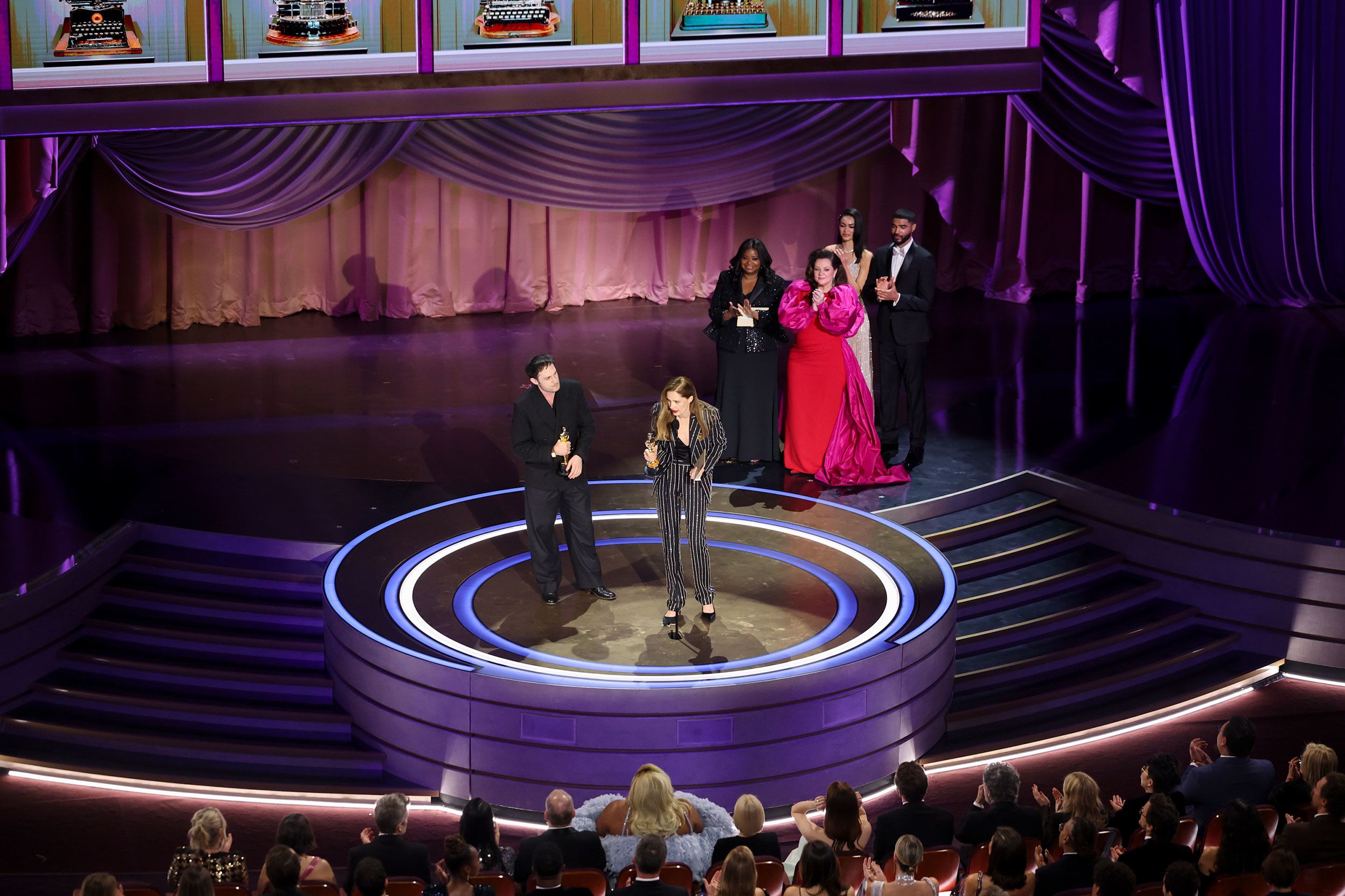 Justine Triet and Arthur Harari accept the Oscar for best original screenplay ("Anatomy of a Fall").