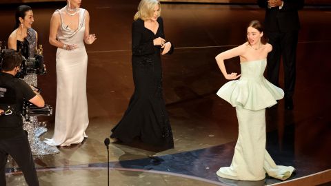 Emma Stone gestures toward her dress as she wins the Oscar for Best Actress for "Poor Things" during the Oscars show at the 96th Academy Awards in Hollywood, Los Angeles, California, U.S., March 10, 2024. REUTERS/Mike Blake