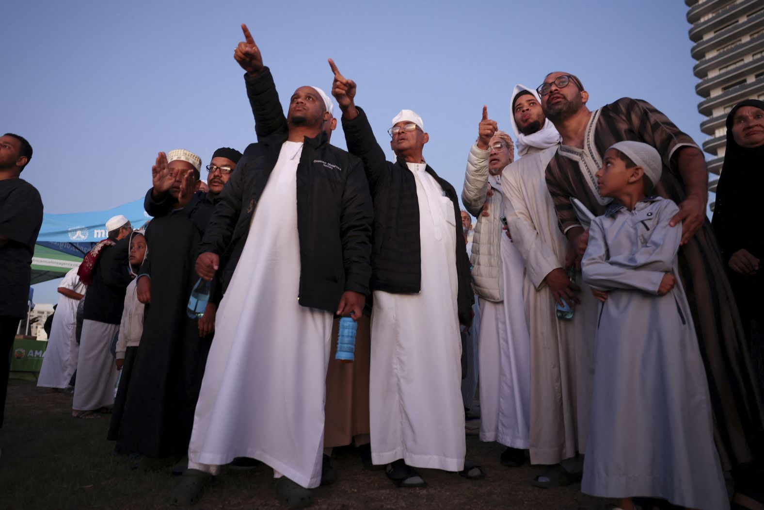 Muslims gesture as they await the sighting of the crescent moon, which marks the start of the holy month of Ramadan, in Cape Town, South Africa.