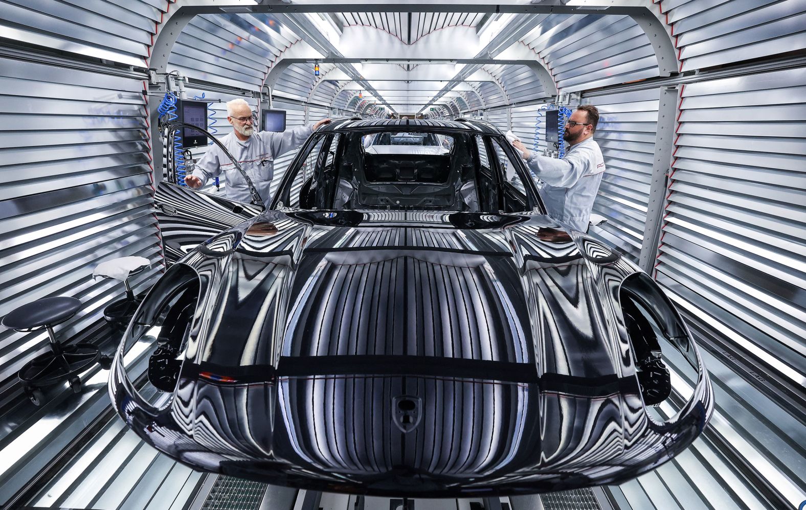 Workers assemble a Porsche Macan at a plant in Leipzig, Germany, on Monday, March 11.