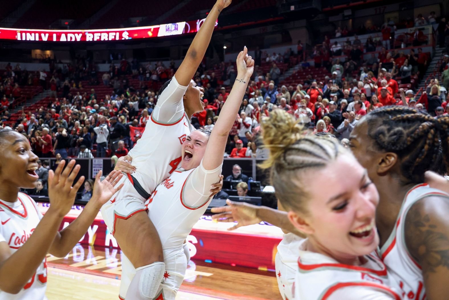 UNLV basketball players celebrate after they defeated San Diego State to win the Mountain West Conference tournament on Wednesday, March 13.