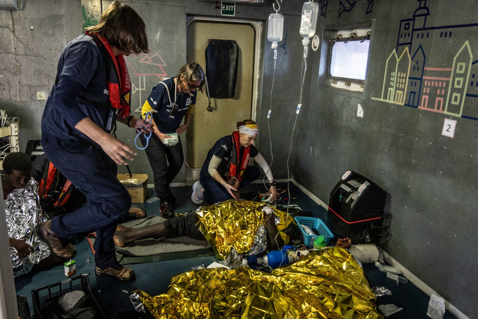 Workers from the humanitarian ship Ocean Viking attend to migrants who were rescued from a deflating rubber dinghy in the central Mediterranean Sea on Wednesday, March 12. Migrants reported that some 50 people died during their journey, which started in Libya a week earlier.