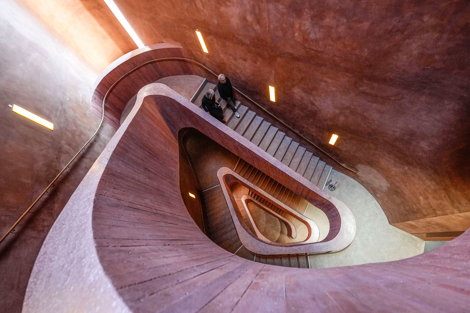 People walk down stairs at the Museum Küppersmühle in Duisburg, Germany, on Friday, March 8.