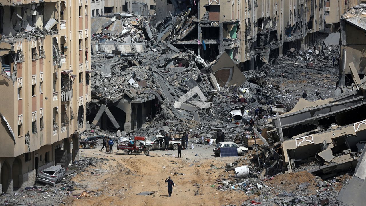 A Palestinian man is walking past the rubble and inspecting the damage in Hamad City, following an Israeli raid in Khan Younis in the southern Gaza Strip, on March 14, 2024. 