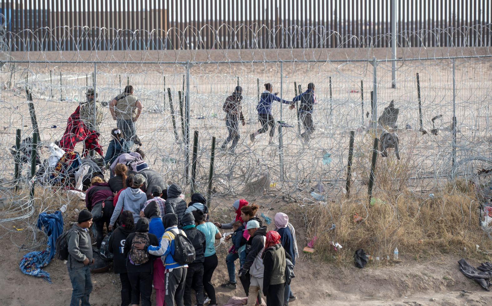 Migrants breach infrastructure set up by the Texas National Guard on the Rio Grande in El Paso, Texas, on Thursday, March 21. US Customs and Border Protection said in a statement Thursday evening that the situation is "under control." The circumstances that led to this incident are unclear.